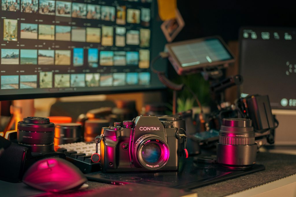 A vintage Contax camera captured in a contemporary photography studio setup with monitors and editing gear.